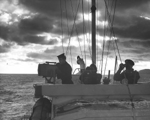 Standing watch on the bridge of a Fairmile are Signalman J. Dowell of Winsor, Ont., Anti-submarine Rating J.Kustra of Winnipeg and Lieut. Cmdr. R.M. Powell of Ottawa, senior officer of the flotilla. Mike Heenan / Royal Canadian Navy collection (R-810).