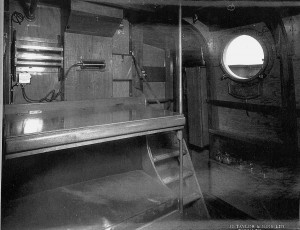 Wheelhouse. Looking aft and showing folding chart table, sten gun locker, recognition light holder and ladder and door to bridge.